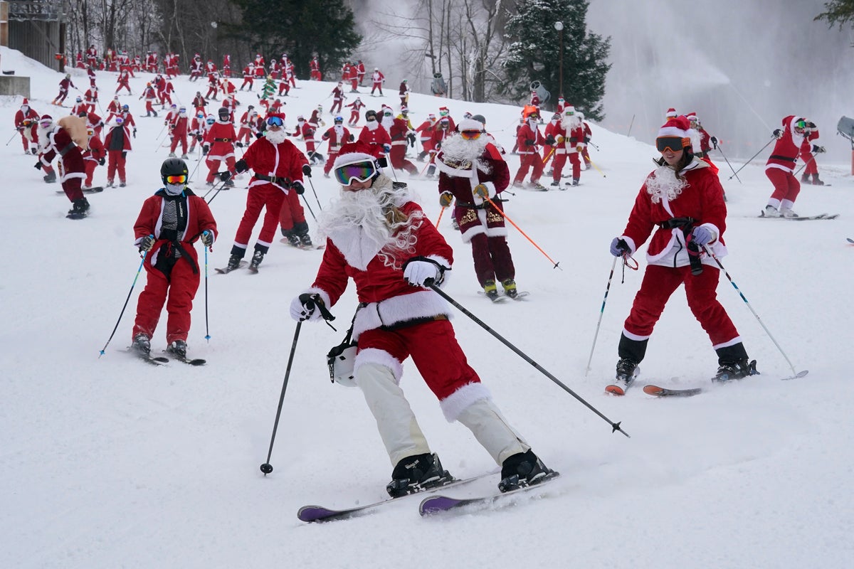 It’s all downhill for 300 skiing Santas, a Grinch and a tree