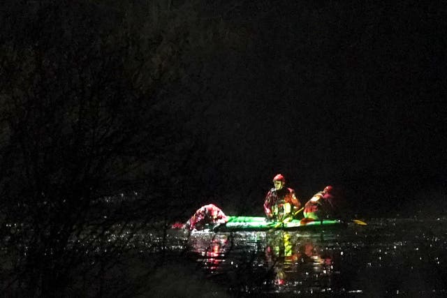Emergency personnel search the lake at the scene in Babbs Mill Park in Kingshurst, Solihull (Jacob King/PA)