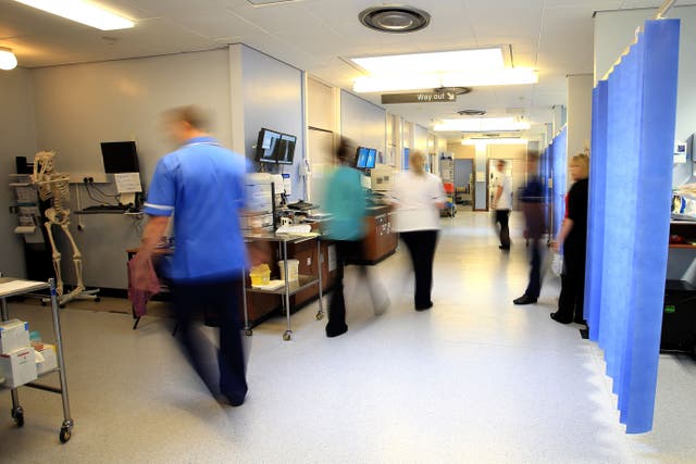 <p>Staff on a NHS hospital ward (Peter Byrne/PA)</p>