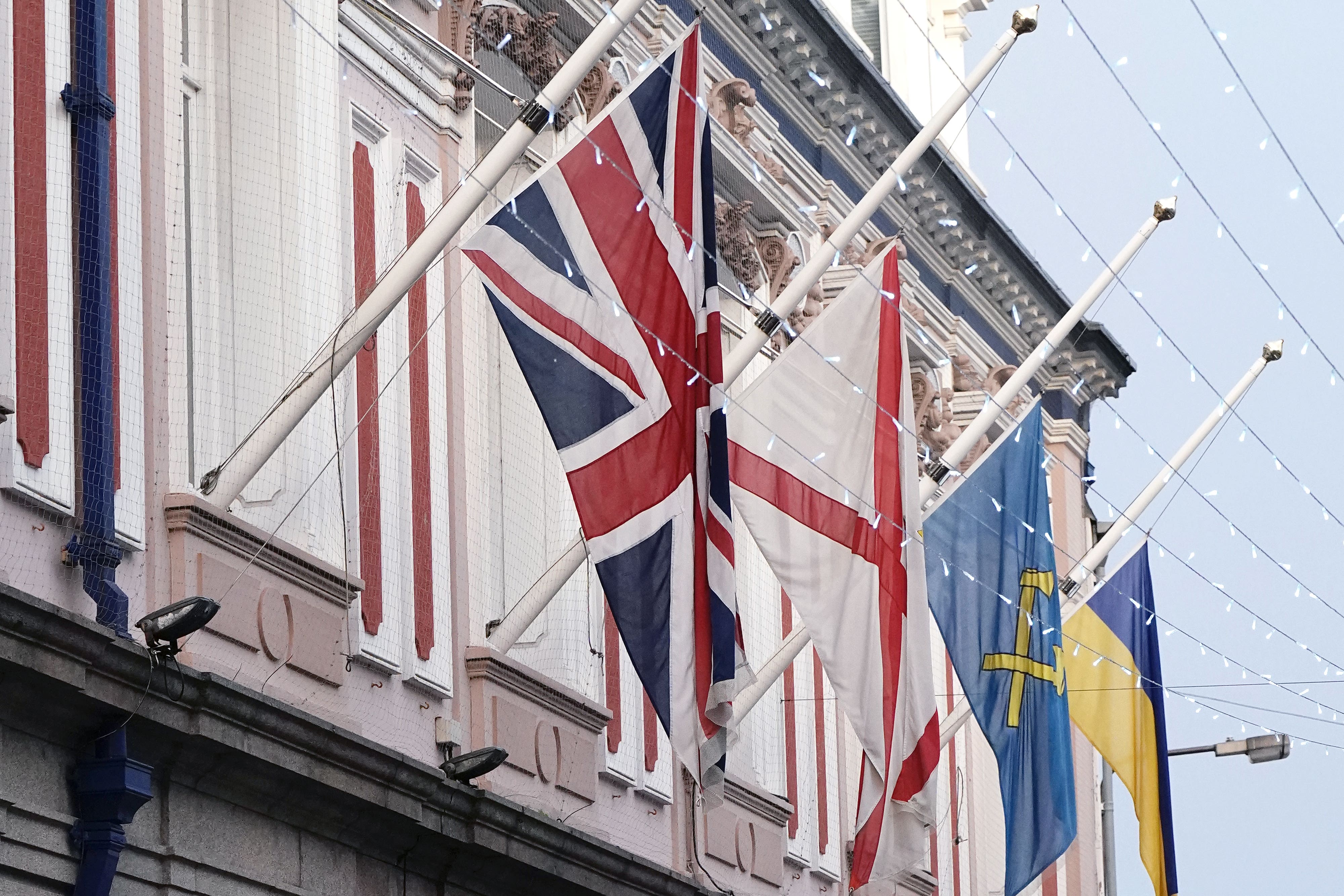 The Union flag, the flag of Jersey, the flag of St Helier and the Ukrainian Flag fly at half-mast over St Helier Town Hall, following an explosion and fire at a block of flats in St Helier, Jersey. Police have said that five people are now confirmed to have died following the blast (Aaron Chown/PA)