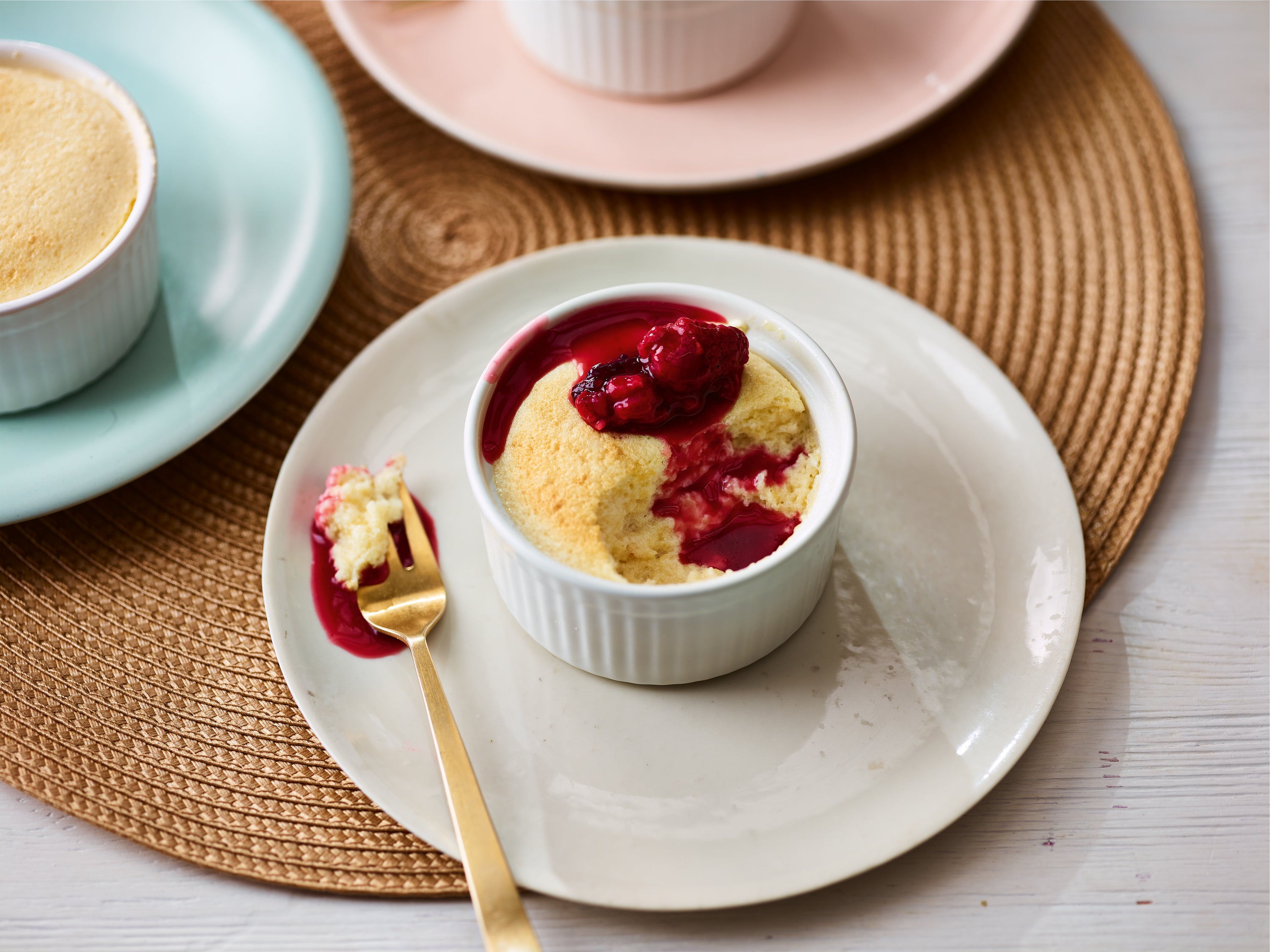 Individual sweet souffles with fruity sauce make for a decadent dessert