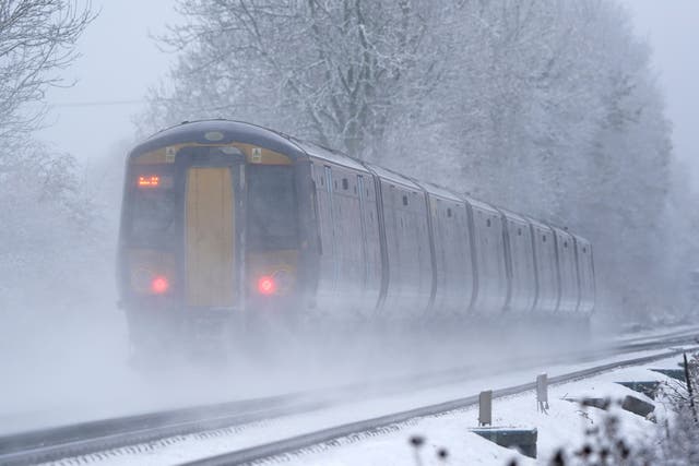 A Southeastern train makes its way through Ashford in Kent as rail services remain disrupted in the icy weather (Gareth Fuller/PA)