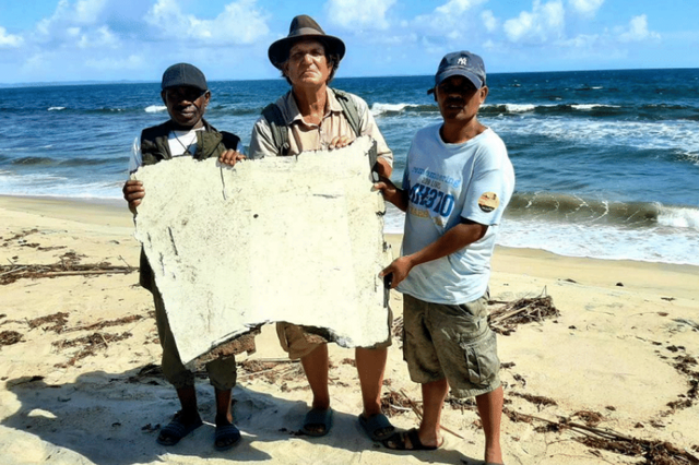 <p>Blaine Gibson with the finders of the  debris</p>