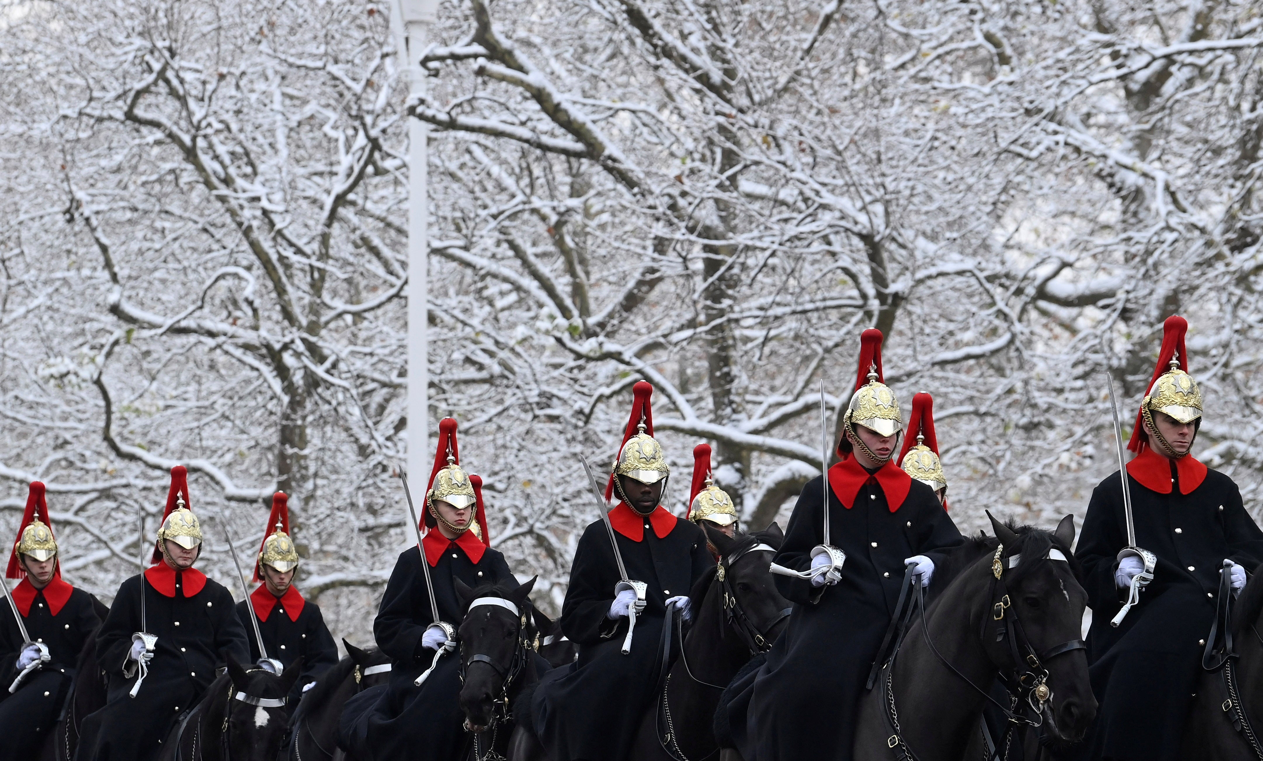 Members of the Household Cavalry take part in ceremonial duties following snowfall on Monday