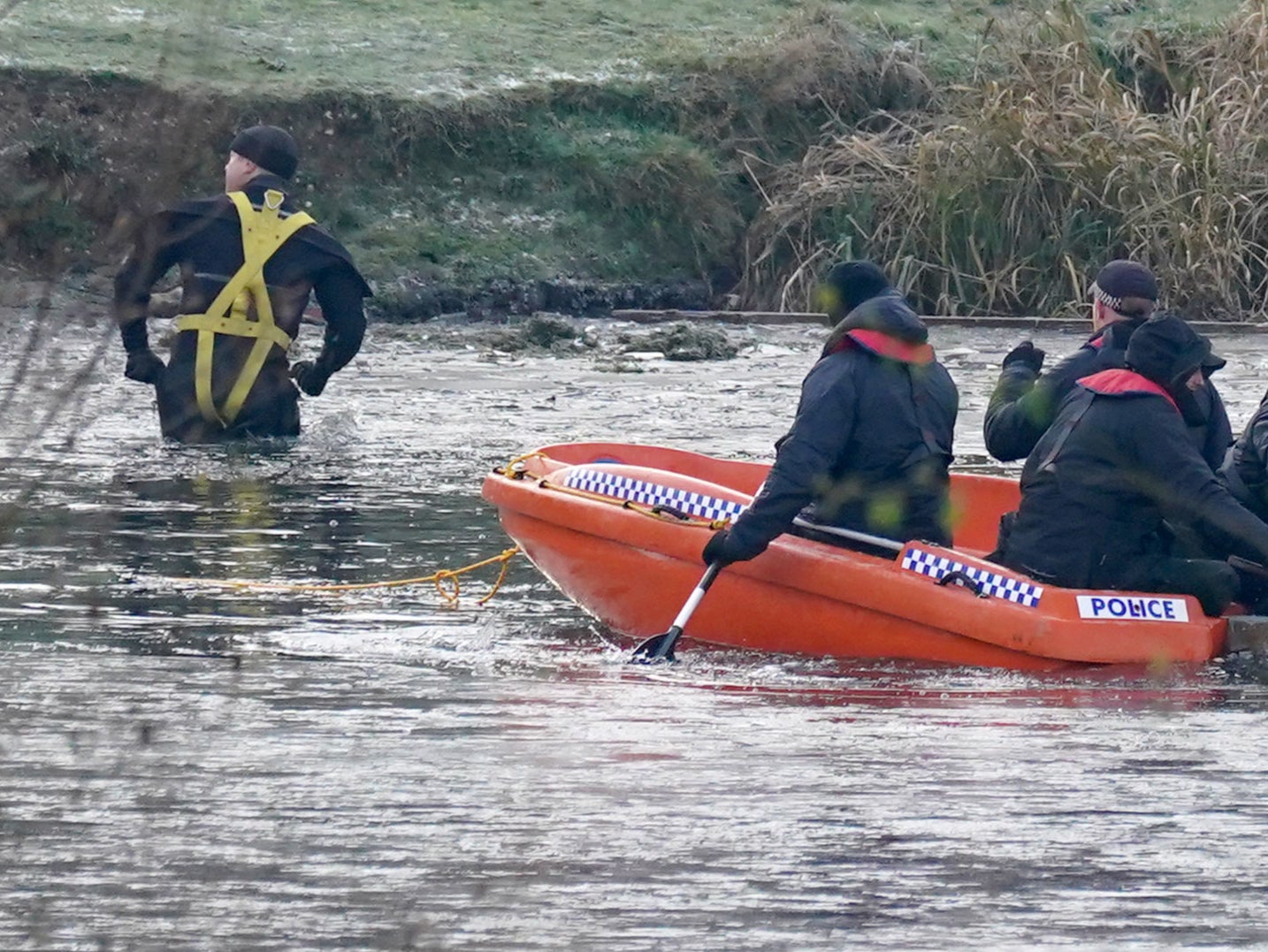 Police break the ice on the lake at Babbs Mill Park in Kingshurst, after the deaths of three boys aged eight, 10 and 11