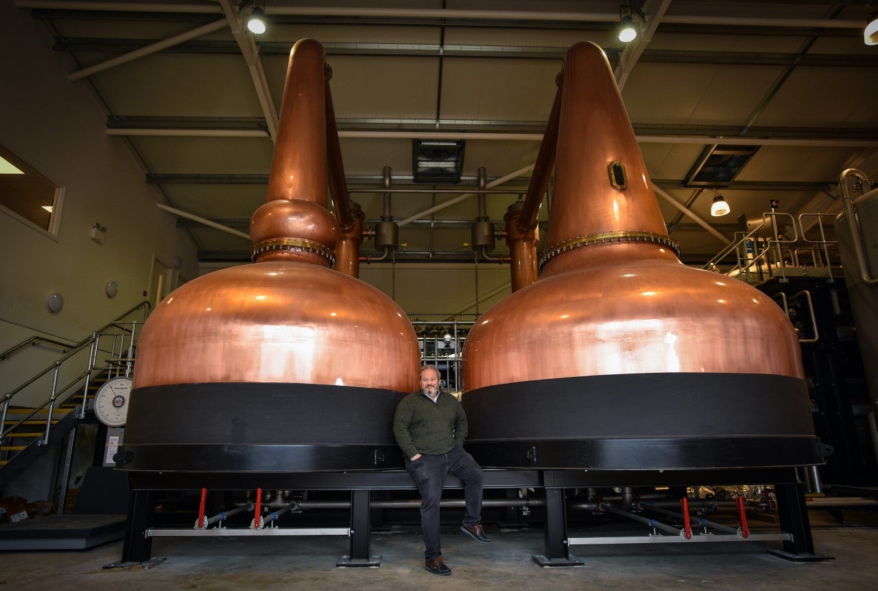 ‘I bet my life savings on whisky’: Dan Szor stands beside stills at his Cotswold Distillery