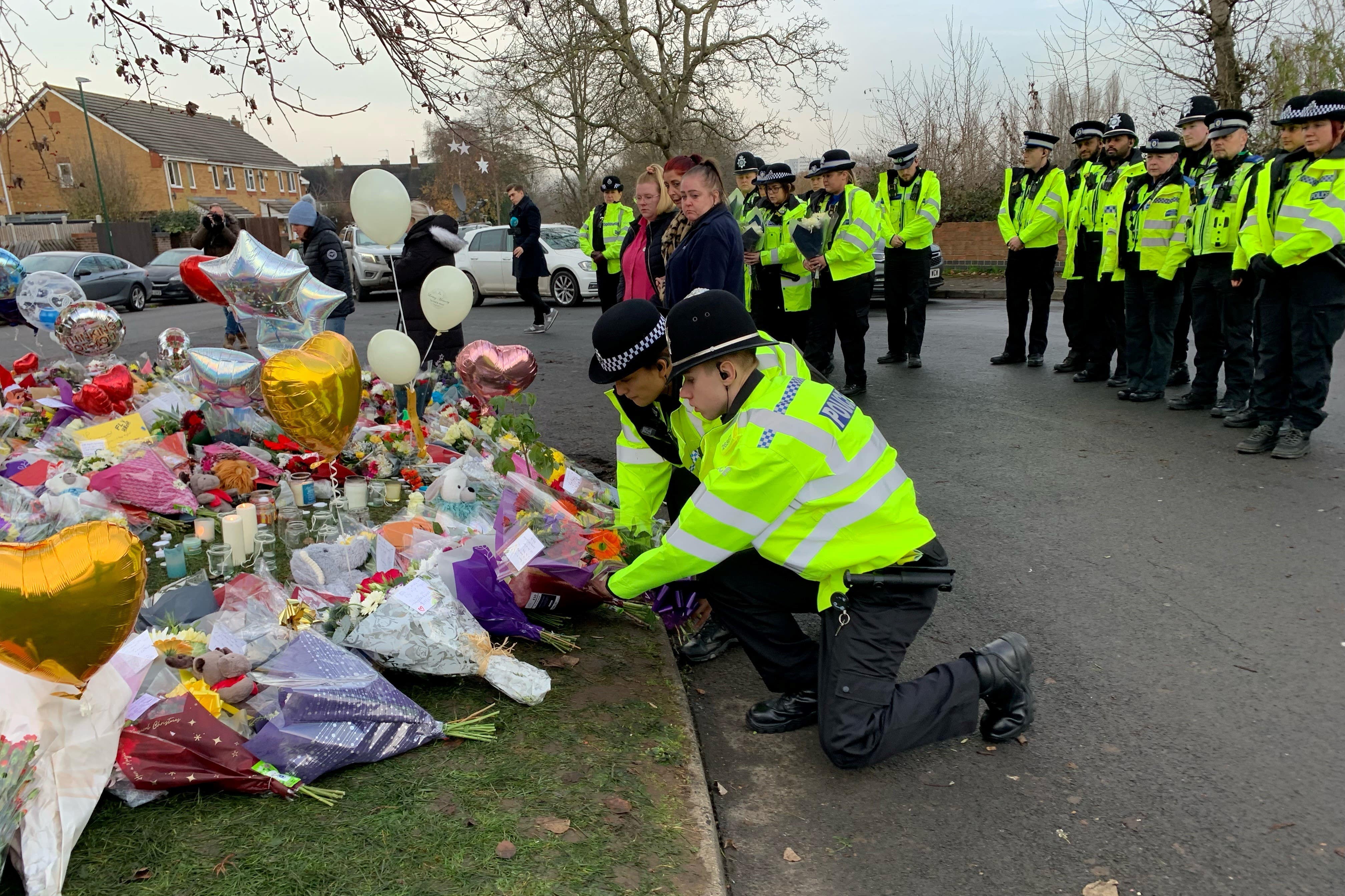 Officers from West Midlands Police lay bouquets of flowers (Richard Vernalls/PA)
