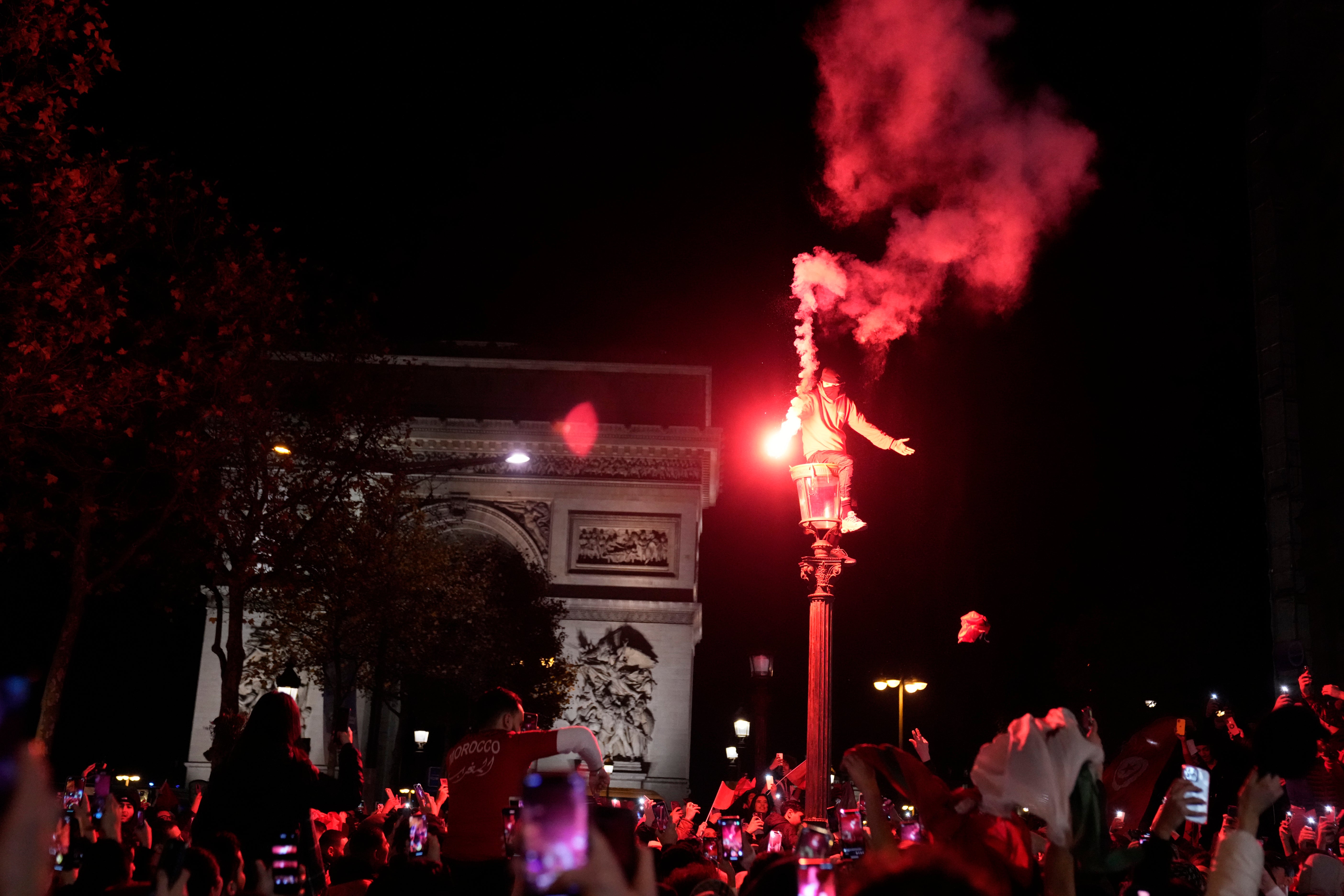 Morocco fans had earlier taken to the Champs-Elysees to celebrate after the quarter-final win over Portugal