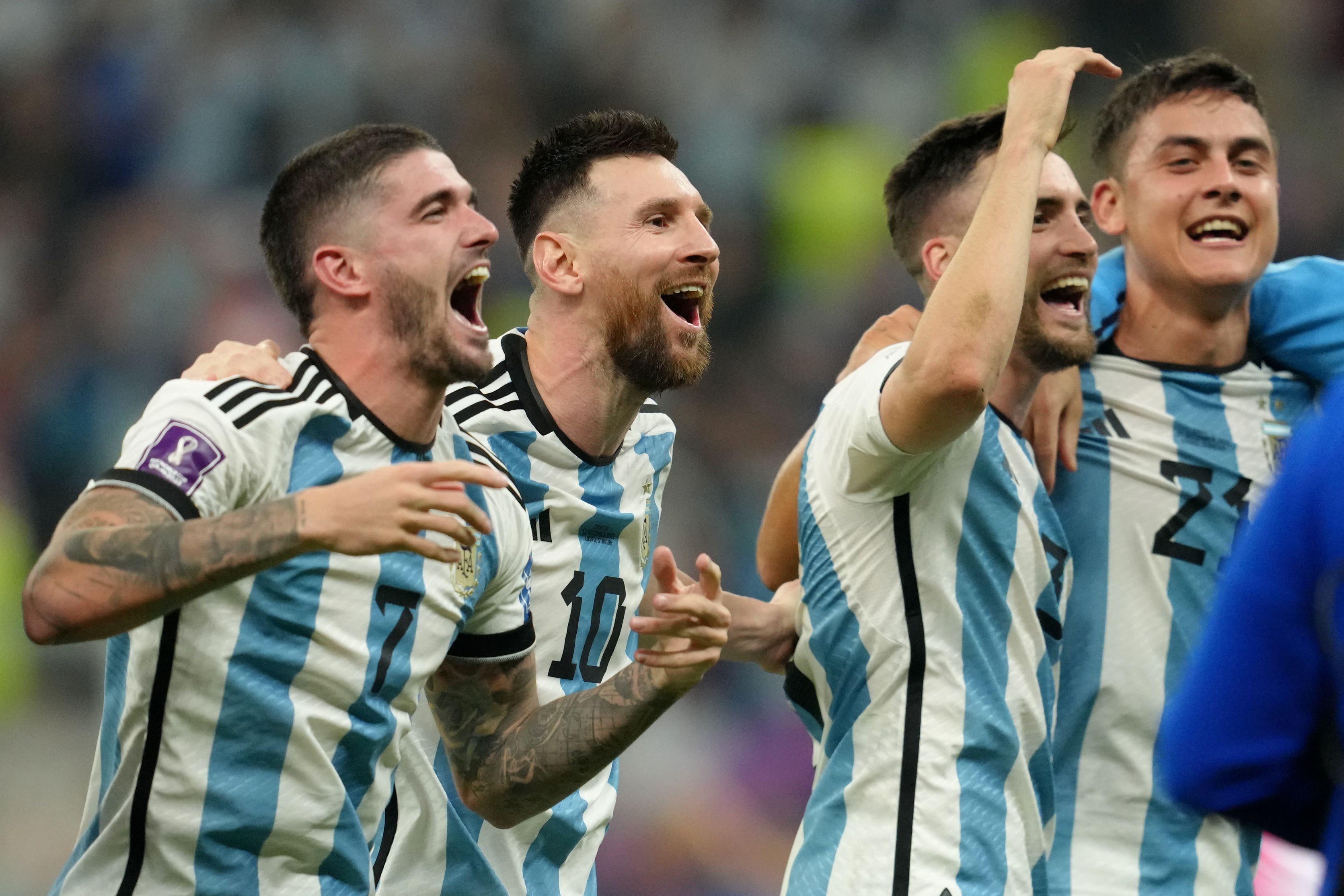 Lionel Messi, second left, celebrates with his team after victory over Croatia
