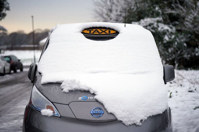 Britons have been warned that snow and ice will continue to cause chaos in parts of the UK on Wednesday, after thousands were left without power in freezing conditions (PA)