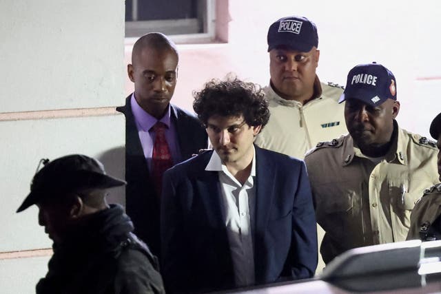 <p>Sam Bankman-Fried, who founded and led FTX until a liquidity crunch forced the cryptocurrency exchange to declare bankruptcy, is escorted out of the Magistrate Court building after his arrest, in Nassau, Bahamas December 13, 2022</p>