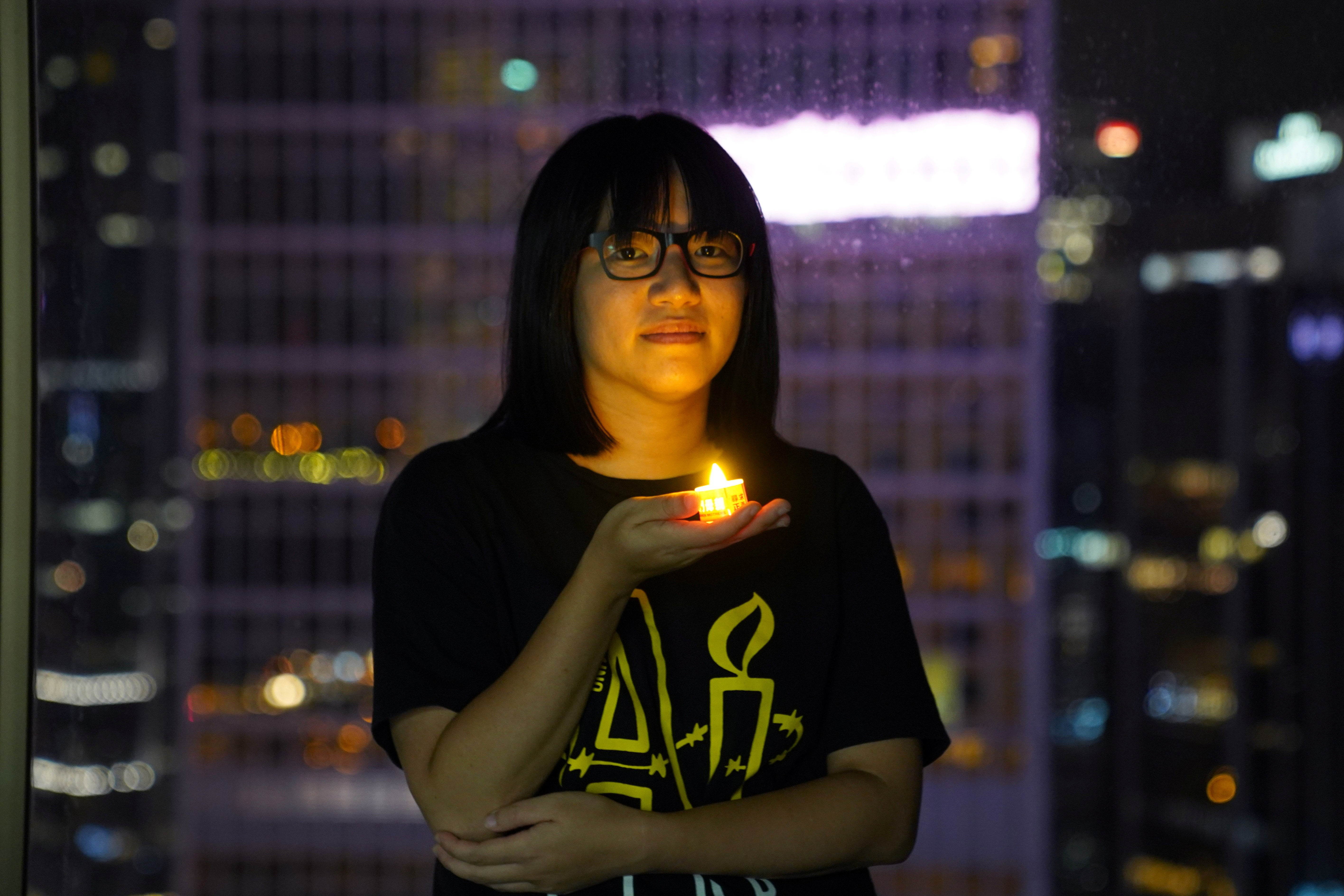 File: Chow Hang-tung poses with a candle ahead of the 32nd anniversary of the crackdown on pro-democracy demonstrators at Beijing’s Tiananmen Square