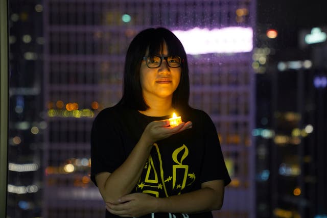 <p>Chow Hang-tung poses with a candle ahead of the 32nd anniversary of the crackdown on pro-democracy demonstrators at Beijing’s Tiananmen Square</p>