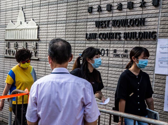 <p>Representational image: People line up outside the West Kowloon court in Hong Kong on 23 September 2021</p>