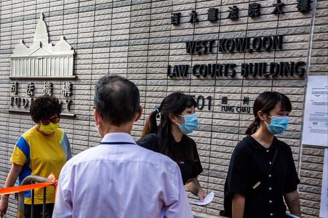 <p>Representational image: People line up outside the West Kowloon court in Hong Kong on 23 September 2021</p>