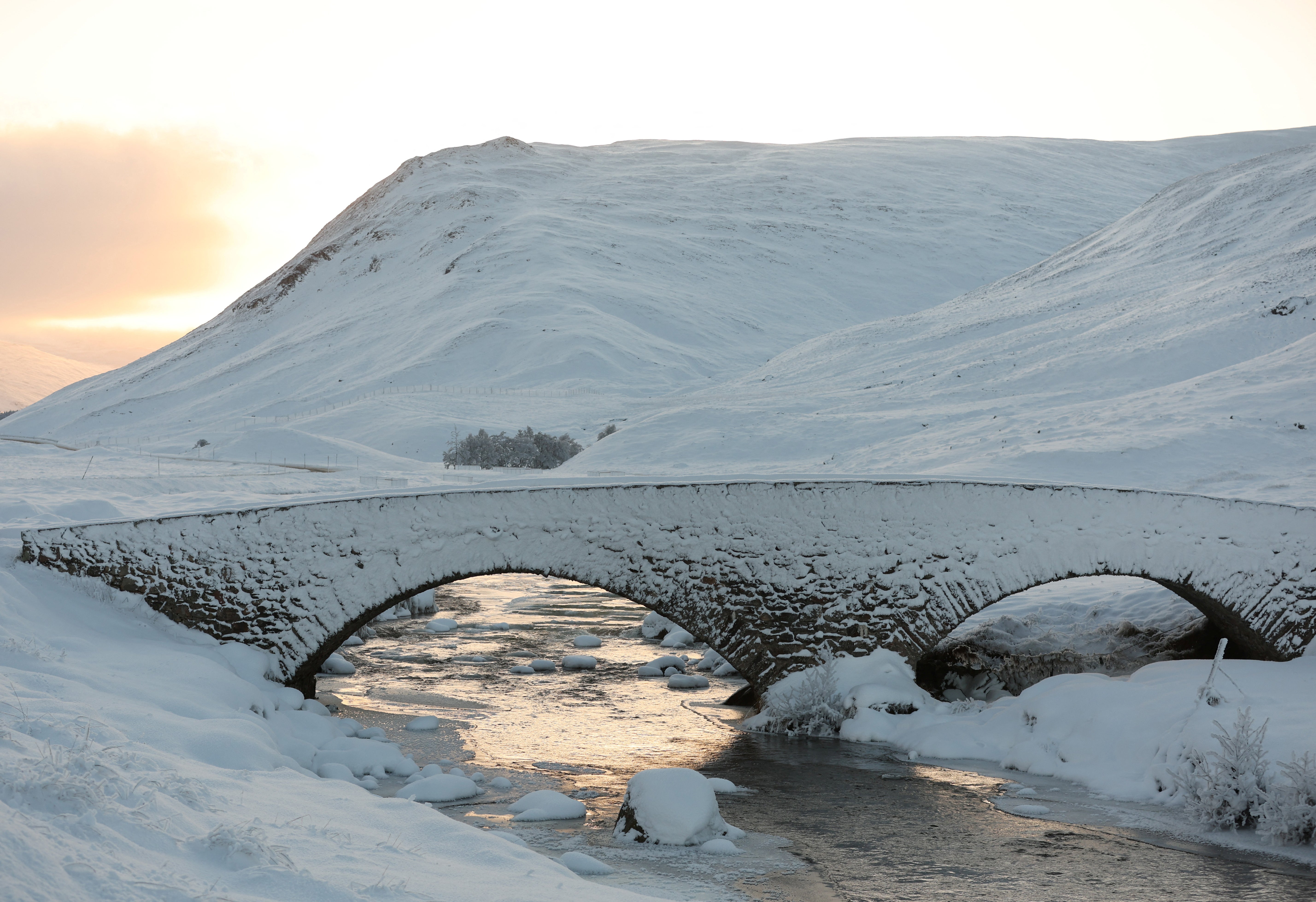 Snow covers a bridge over Clunie Water near Braemar, Scotland