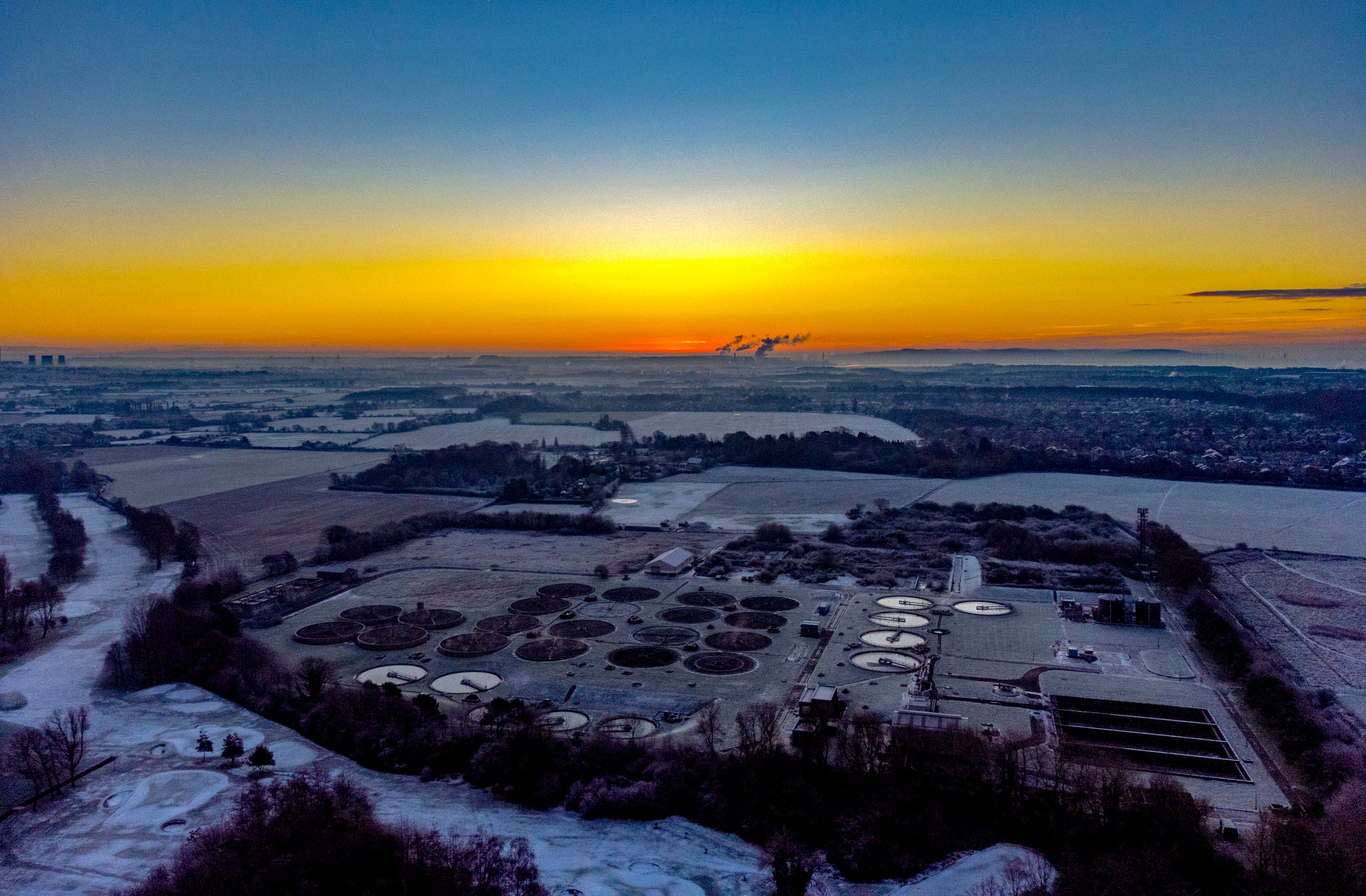 The sun rises over a water treatment plant in Liverpool