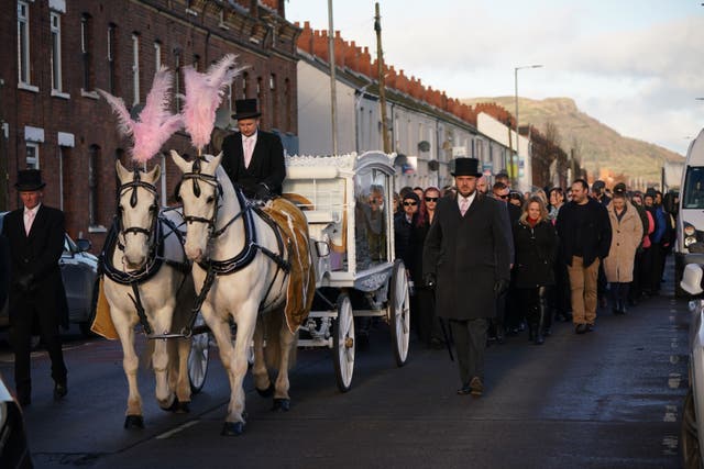 Mourners walk behind the horse-drawn carriage carrying the coffin of Stella-Lily McCorkindale through Belfast ahead of her funeral. Five-year-old Stella-Lily died after a case of Strep A was reported at the primary school she attended (PA)