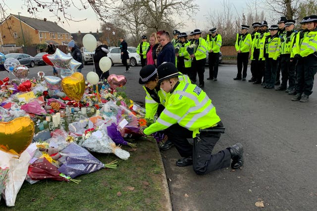 Officers from West Midlands Police lay bouquets of flowers at the scene (Richard Vernalls/PA)