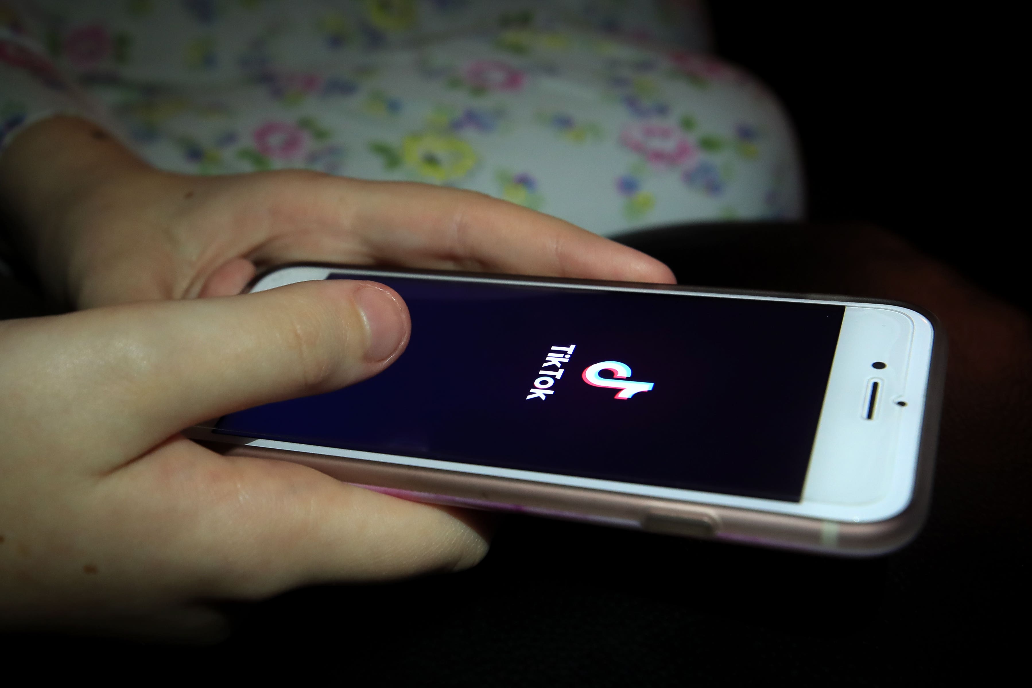 A young girl uses the TikTok app on a smartphone (Peter Byrne/PA)