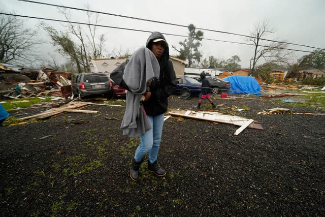 <p>Chelsi Bovie holds her niece's dog that she rescued from her home after a tornado tore through the area in Killona, Louisiana, about 30 miles west of New Orleans</p>