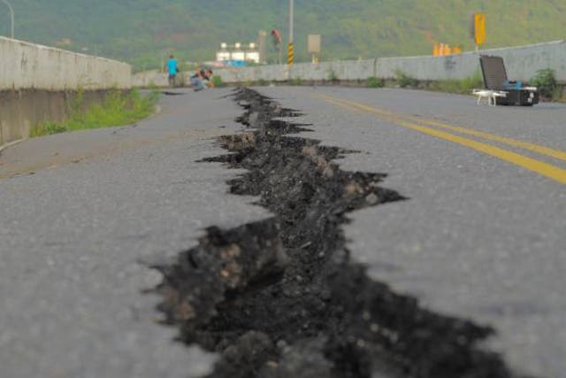 <p>File: A fissure is seen along a road by the collapsed Kaoliao bridge in eastern Taiwan’s Hualien county on 19 September 2022, following a 6.9 magnitude earthquake on 18 September</p>