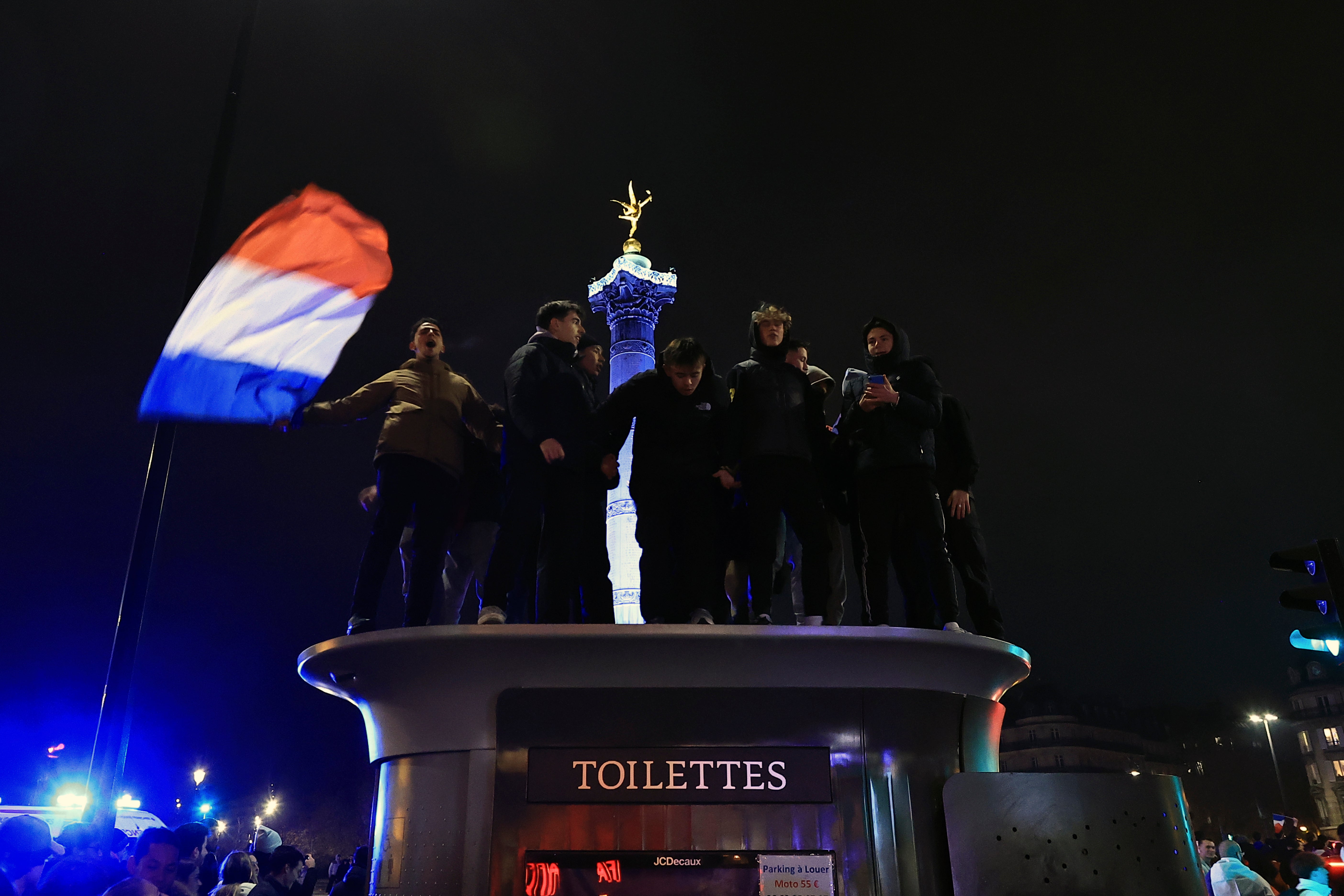 Supporters of France react in Place de la Bastille at the end of the 2-0 victory over Morocco