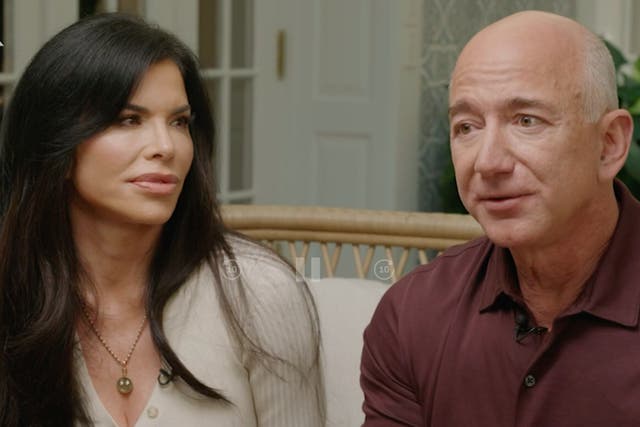 <p>Jeff Bezos and girlfriend Lauren Sanchez during a CNN interview where the Amazon founder confirmed he would give away most of his wealth in his lifetime</p>