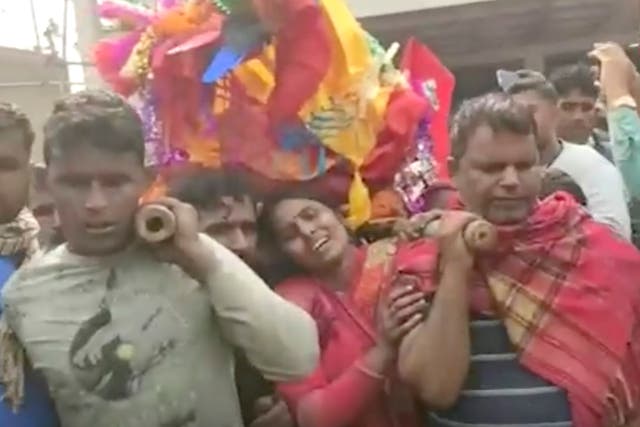 <p>This image from a video shows relatives preparing to cremate the body of a victim suspected to have died after drinking tainted liquor in Saran district of Bihar state, India, Thursday, 15 December 2022</p>