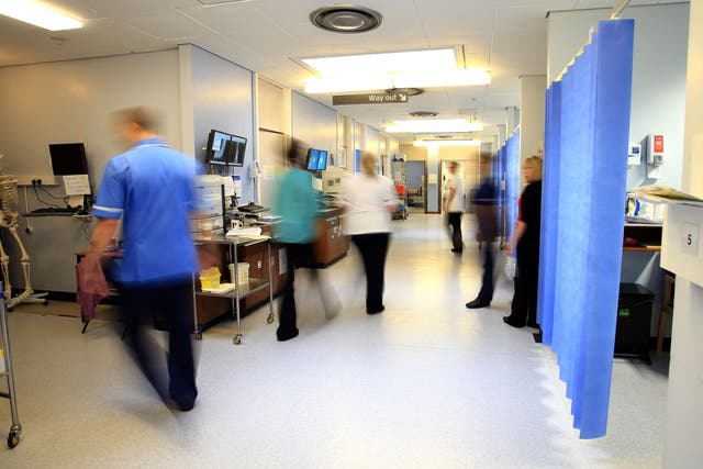 File photo of staff in an NHS hospital ward (Peter Byrne/PA)