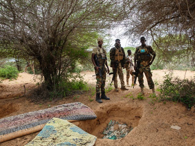 <p>Danab and Gorgor soldiers stand near a former al-Shabab camp in Masjid Ali Guduud, an area recently taken back from al-Shabab control in Somalia</p>