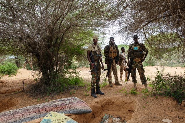 <p>Danab and Gorgor soldiers stand near a former al-Shabab camp in Masjid Ali Guduud, an area recently taken back from al-Shabab control in Somalia</p>