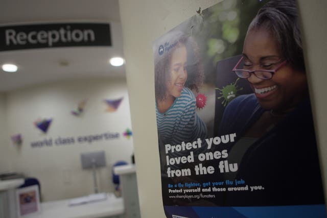 A flu information poster on the wall of a London hospital (Yui Mok/PA)