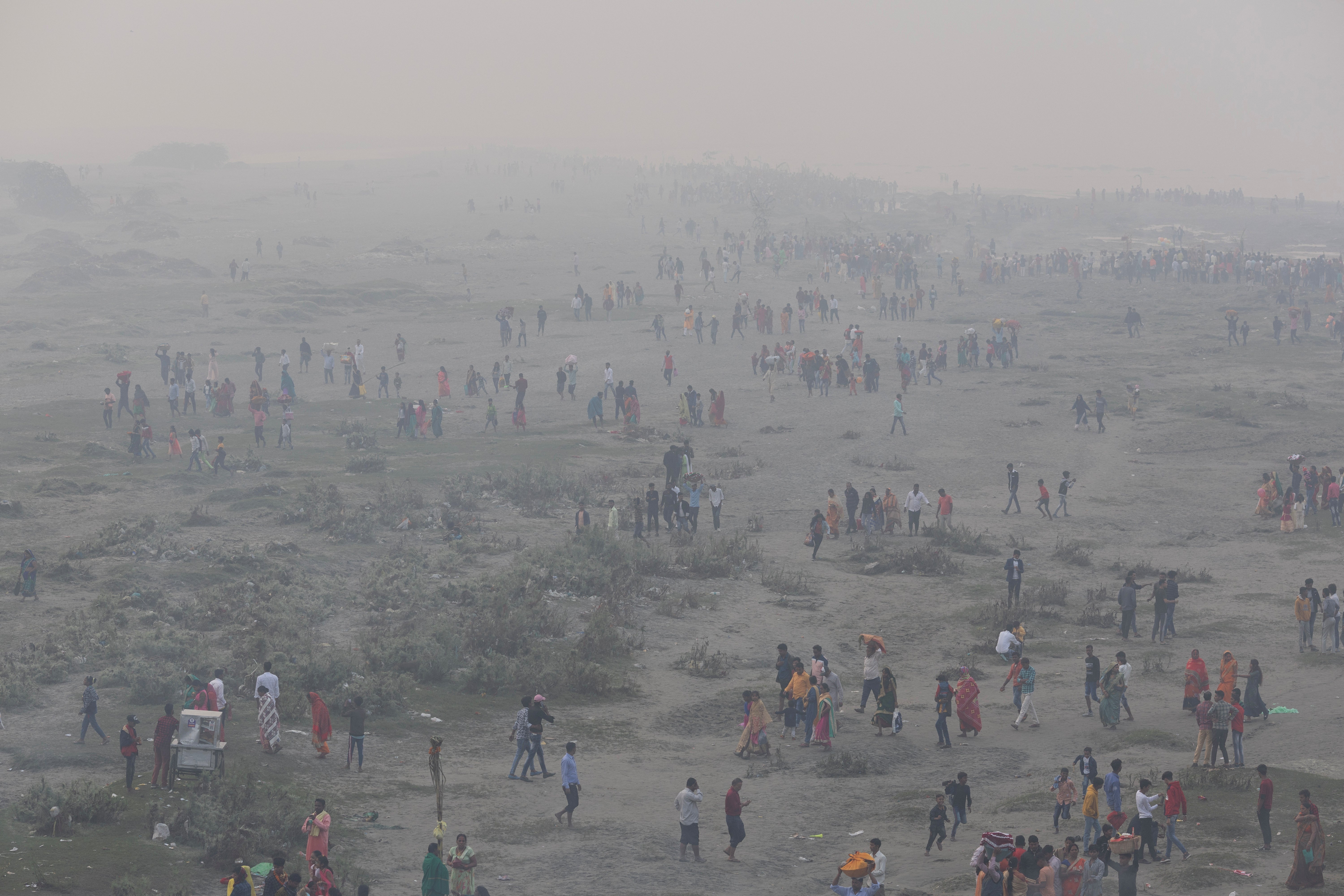 Hindu devotees gather to worship on the banks of the Yamuna river