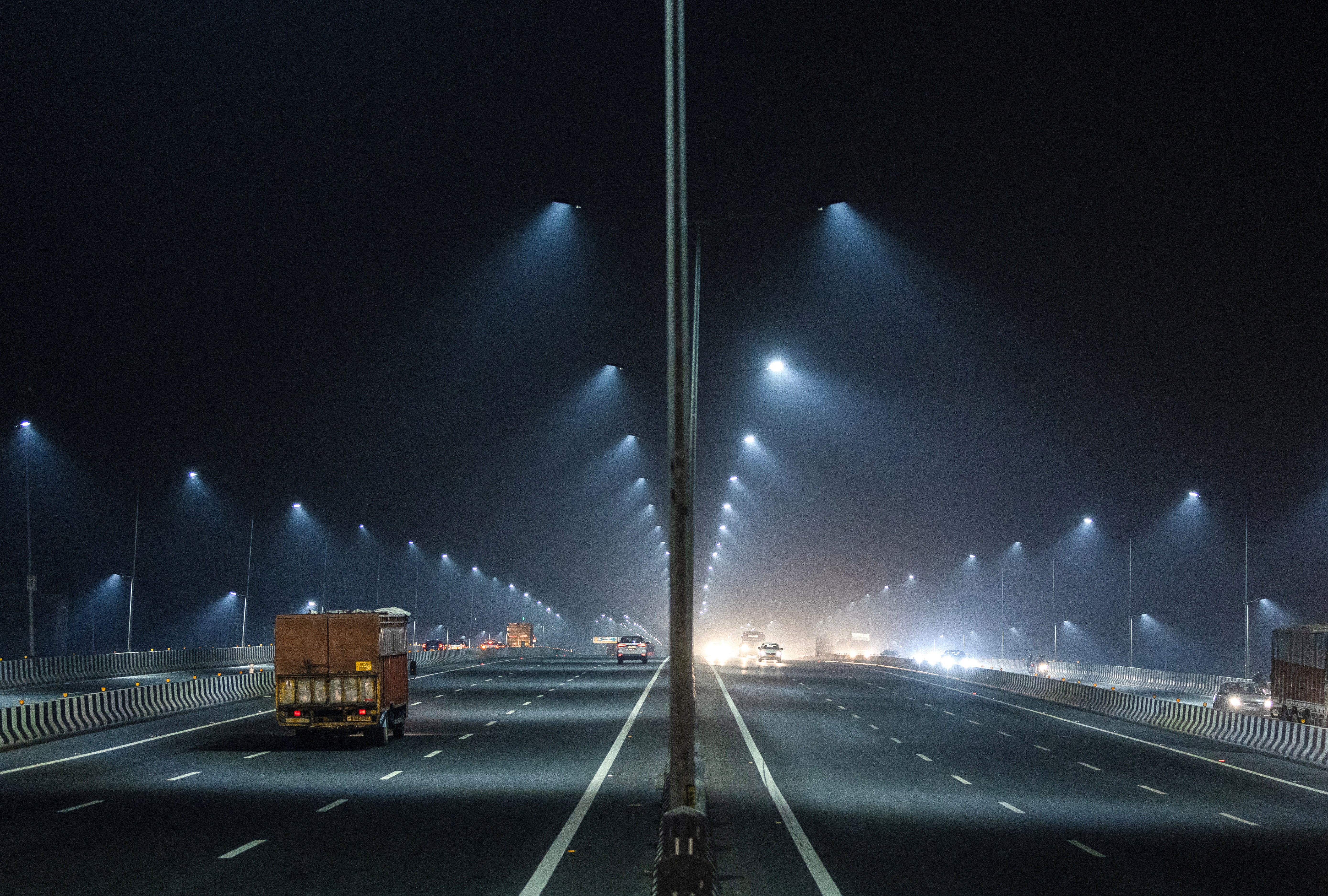 Traffic moves along a highway in the haze