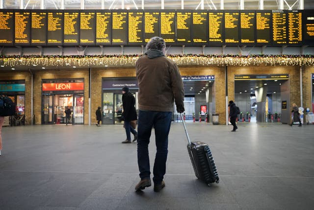 Passengers view departure boards at King’s Cross station in London during a strike by members of the Rail, Maritime and Transport union (James Manning/PA)