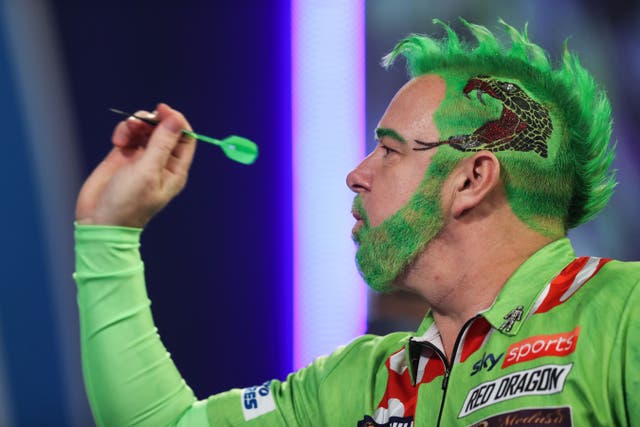 Peter Wright came dressed as the Grinch as he began the defence of his World Championship title (Kieran Cleeves/PA)