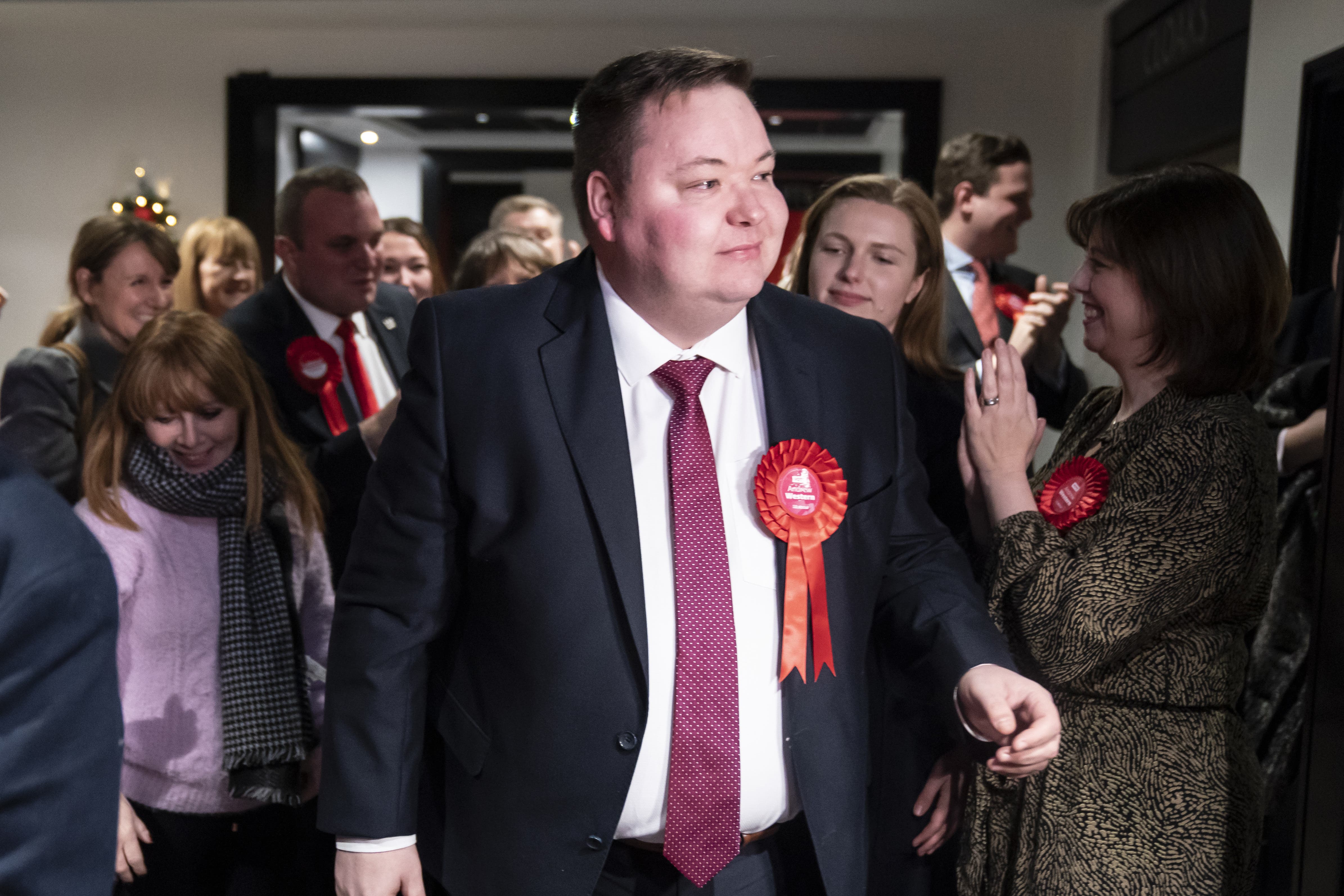 Labour candidate Andrew Western is greeted by party activists as he arrives at Old Trafford, as votes are counted at Old Trafford in Greater Manchester for the Stretford and Urmston by-election after Kate Green stepped down. Nine candidates are bidding to succeed her as the MP for the Labour stronghold in the south west of Greater Manchester. Picture date: Friday December 16, 2022.