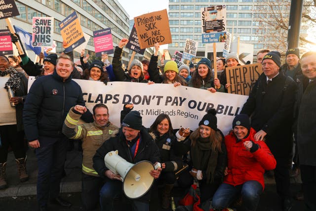 Firefighters join members of the Royal College of Nursing (RCN) on the picket line outside St Thomas’ Hospital in London (Lucy North/PA)