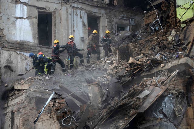 <p>Ukrainian State Emergency Service firefighters clear the rubble at the building which was destroyed by a Russian attack in Kryvyi Rih</p>