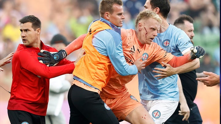 <p>Melbourne derby abandoned after fans storm pitch and attack goalkeeper Tom Glover</p>