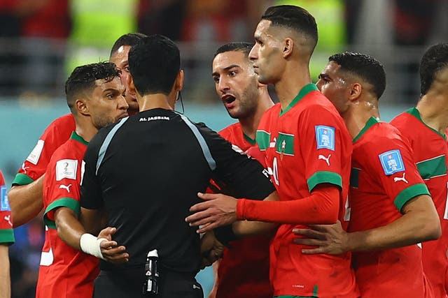 <p>Morocco players remonstrates with the referee Abdulrahman Al Jassim</p>