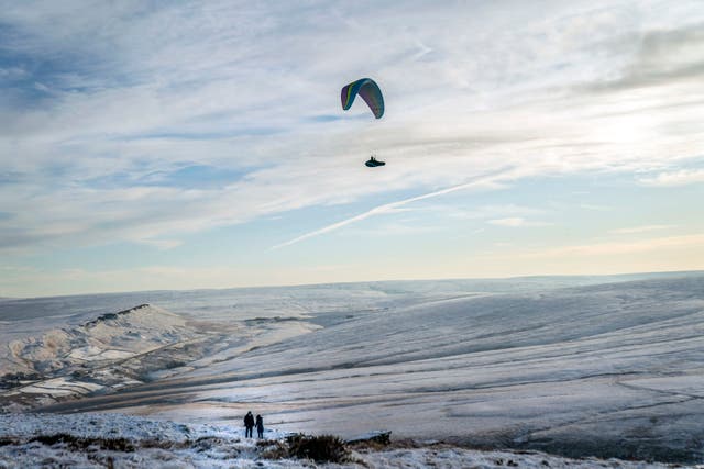 <p>A paraglider over Marsden Moor in the South Pennines during wintry conditions in the UK last week </p>