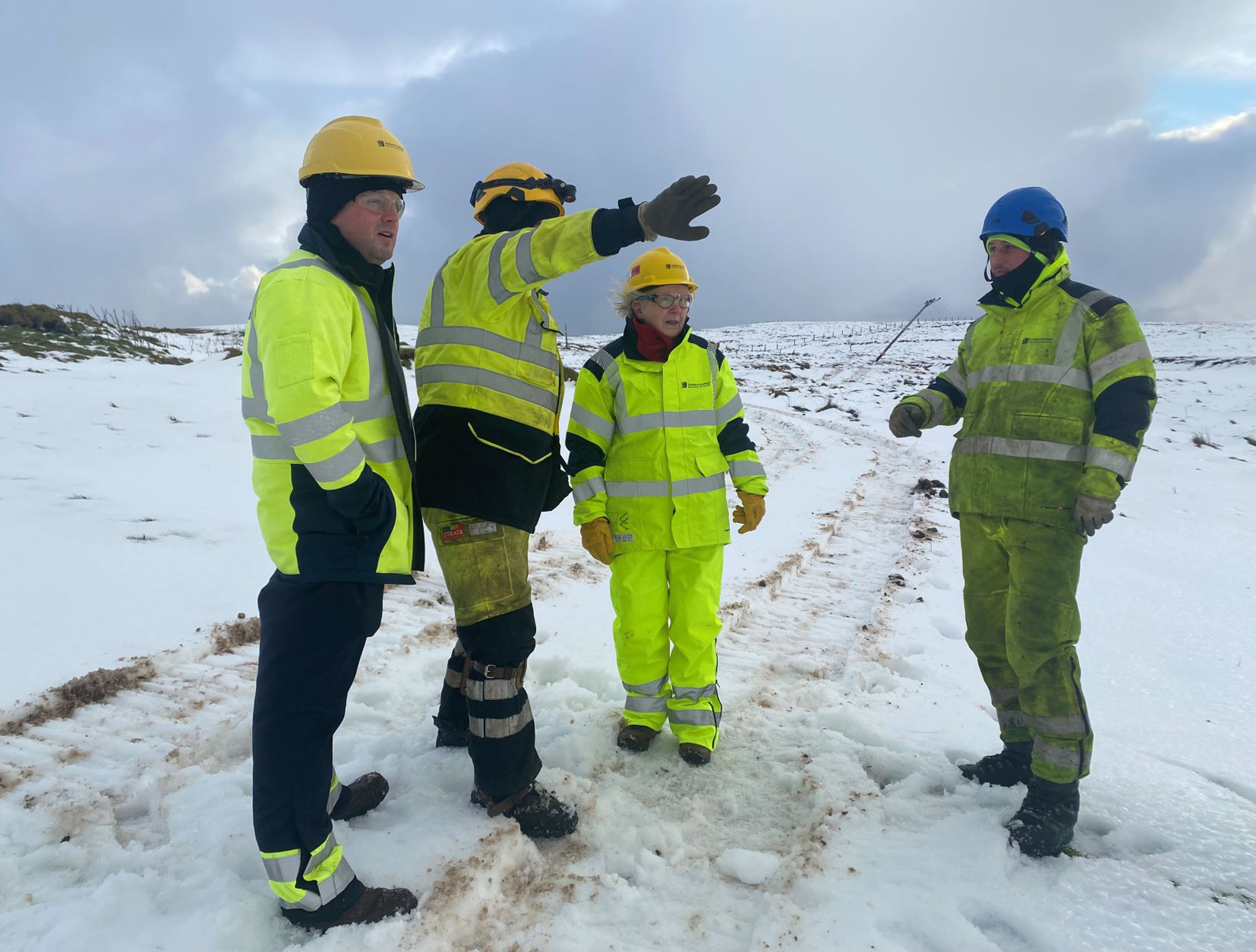 Beatrice Wishart MSP (second from right) with SSEN workers at Effirth, Shetland during efforts to restore power to the area