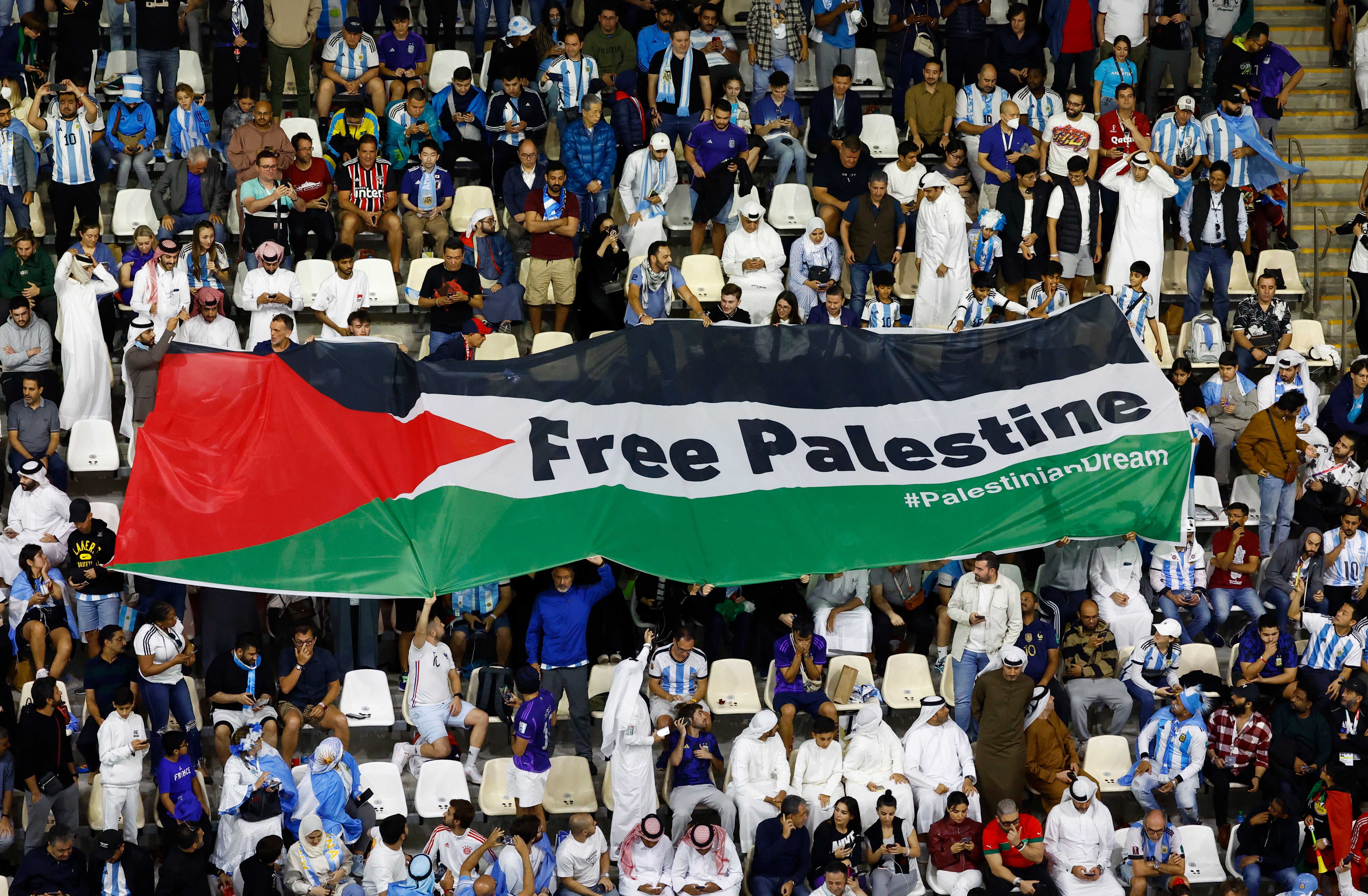 Fans display a flag reading ‘Free Palestine’ in the stands