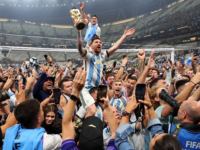 <p>Lionel Messi raises the World Cup trophy into the air during Argentina’s celebrations</p>