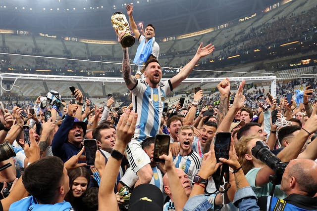 <p>Lionel Messi raises the World Cup trophy into the air during Argentina’s celebrations</p>