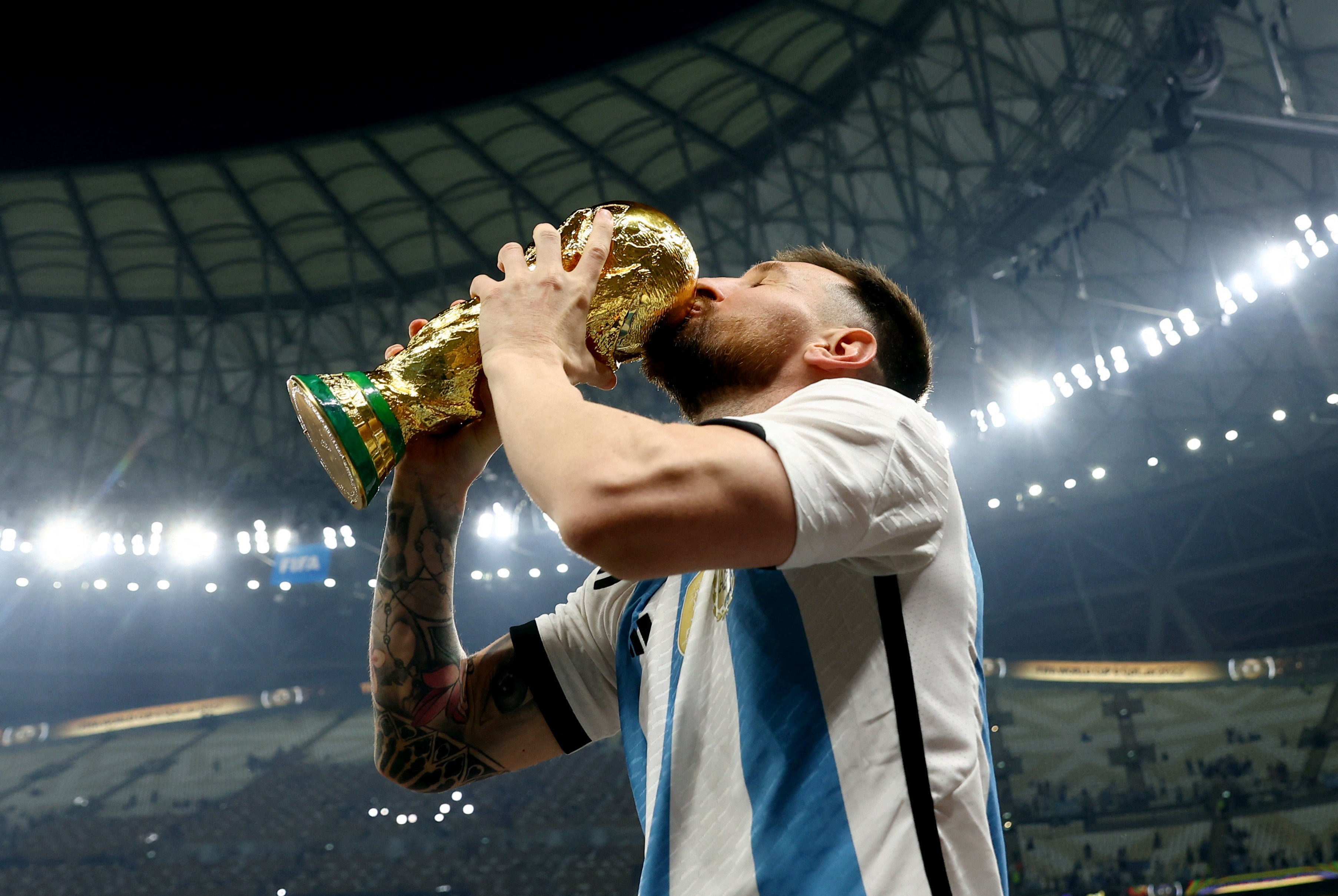 Lionel Messi kisses the trophy