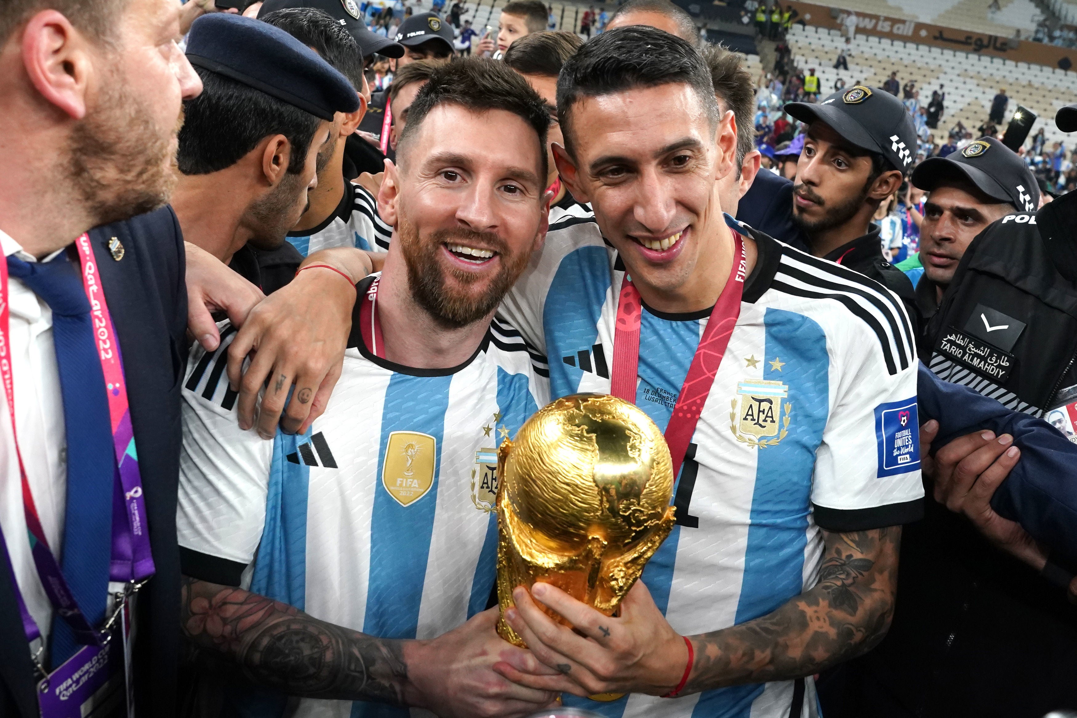 Messi and Angel Di Maria hold the trophy together