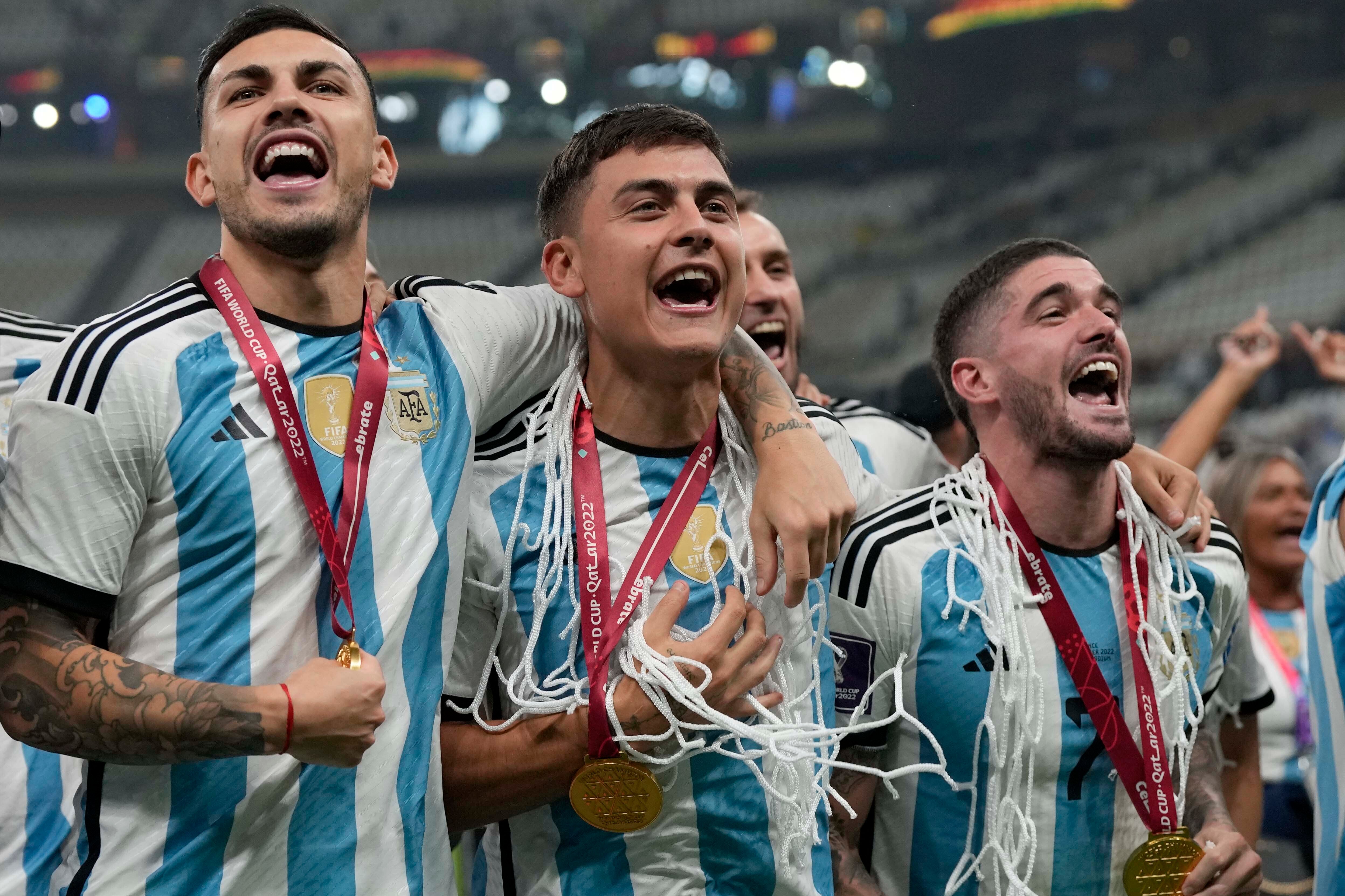 Argentina players celebrate with the goal netting around